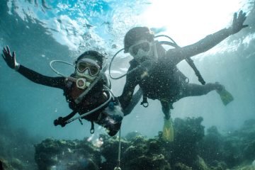 Underwater shot of two people diving